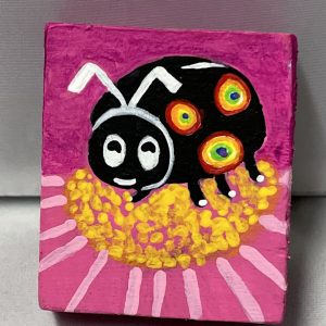 tiny painting of a colorful ladybug