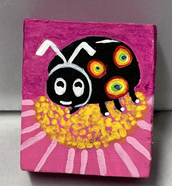 tiny painting of a colorful ladybug