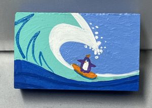 tiny painting of a surfing penguin