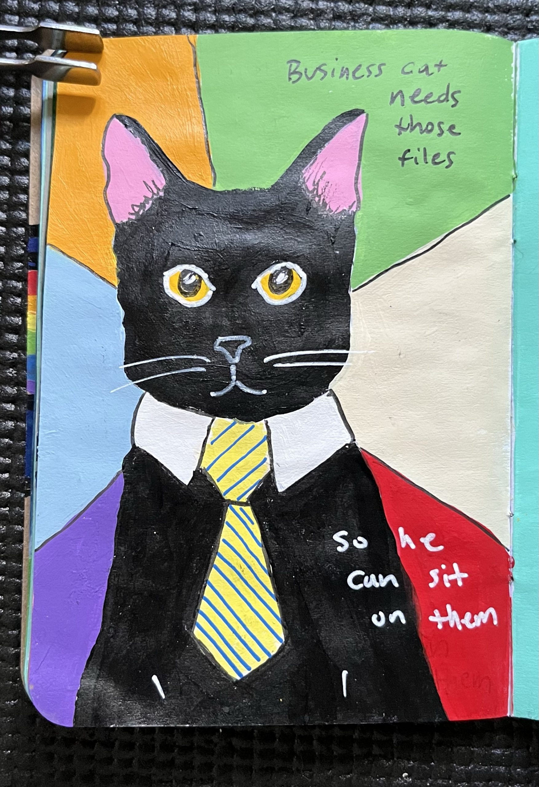 A painted black cat in a tie sits in front of a colorful backdrop.